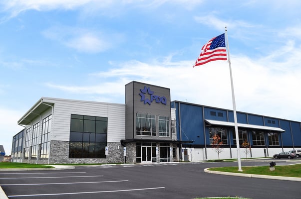 PDQ Headquarters with an American Flag on a flagpole in the foreground