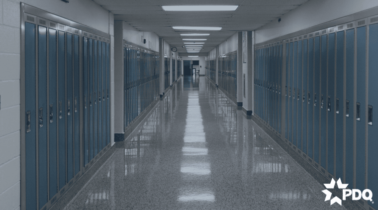 School highway with a double door exit at the end of the hallway.