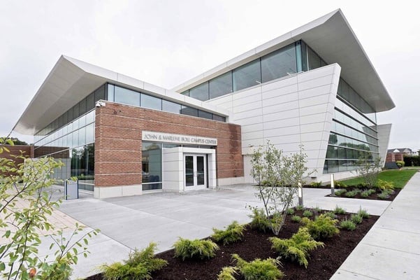 University Liggett School building with modern architectural design, featuring large windows and a welcoming entrance surrounded by greenery.